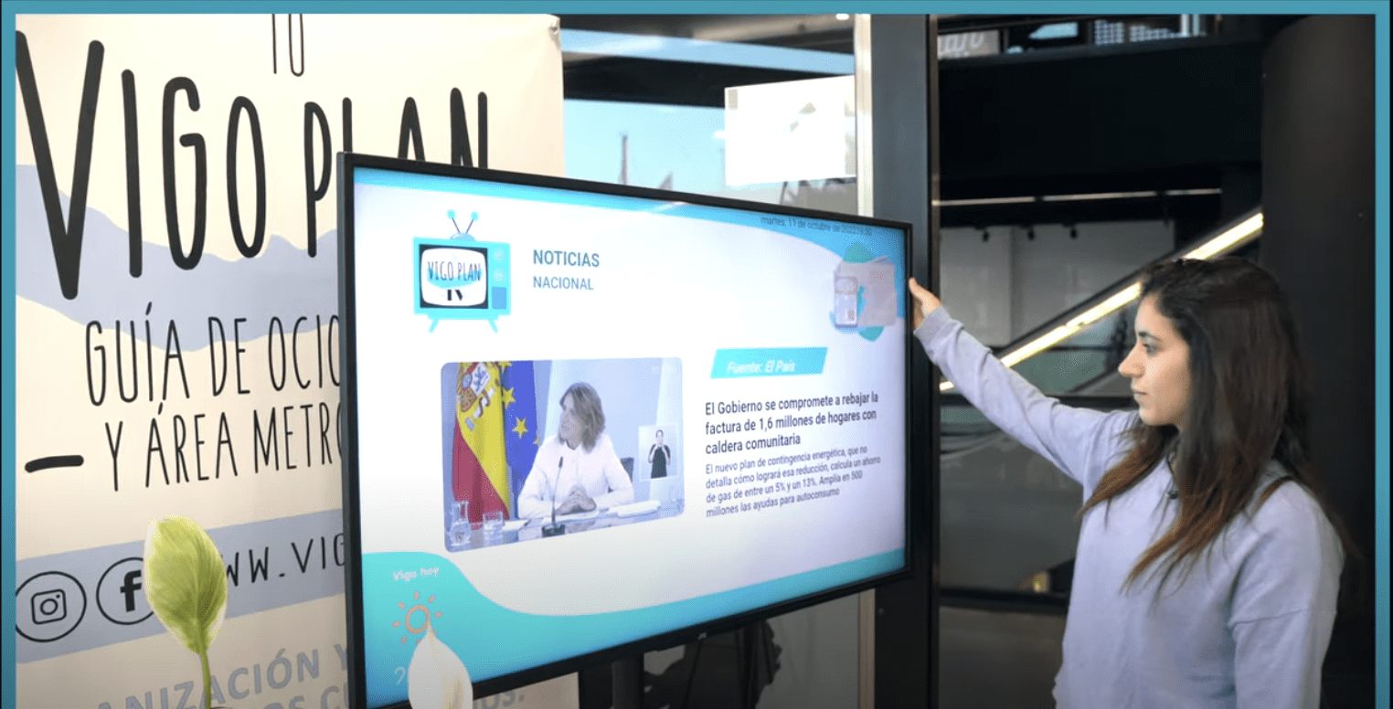Pacientes en sala de espera mirando una pantalla informativa
